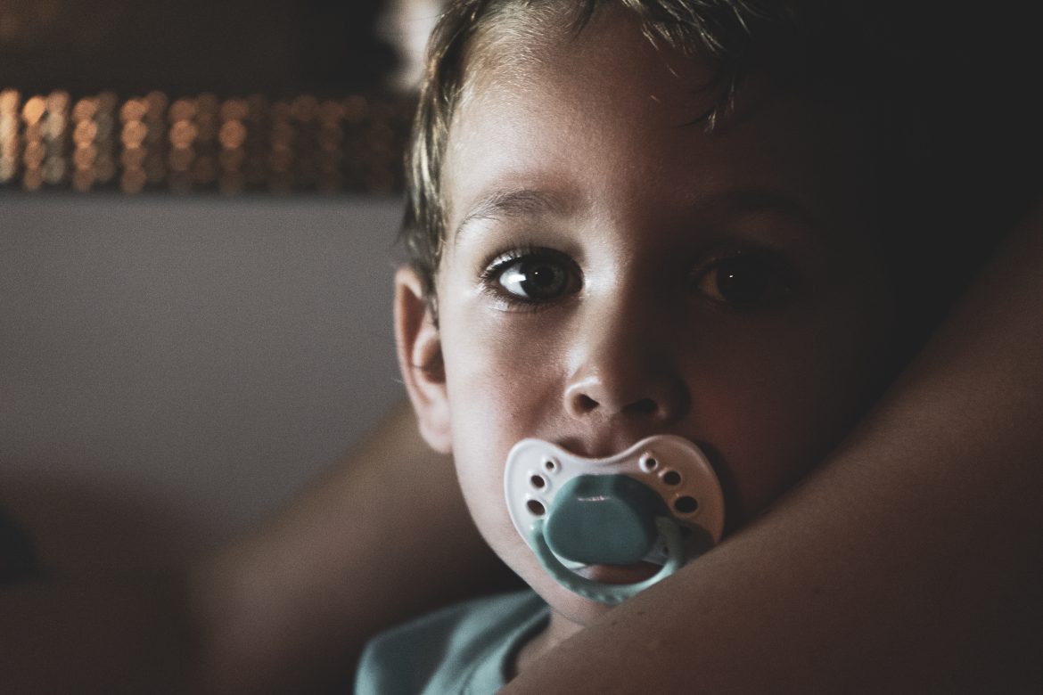 close-up-photo-of-boy-with-pacifier-in-his-mouth-2602089